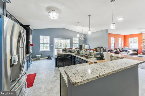 a living room with furniture a fireplace and a floor to ceiling window