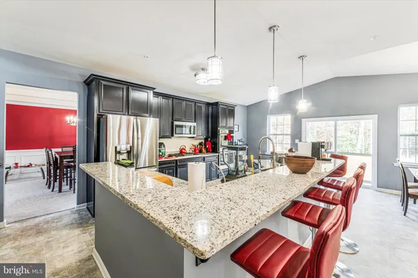 a living room with furniture a fireplace and large windows