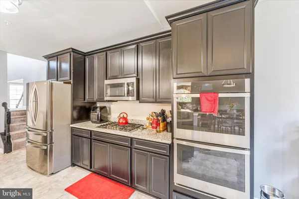 a living room with fireplace furniture and a large window