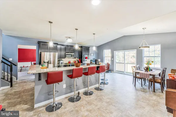 a view of a hallway with wooden floor and furniture