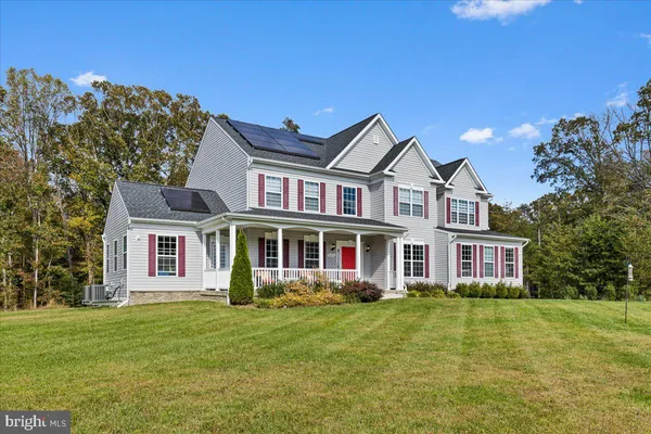 a view of a livingroom with wooden floor and stairs