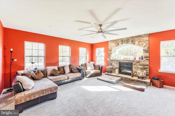 a spacious bedroom with a bed a dresser and a chandelier