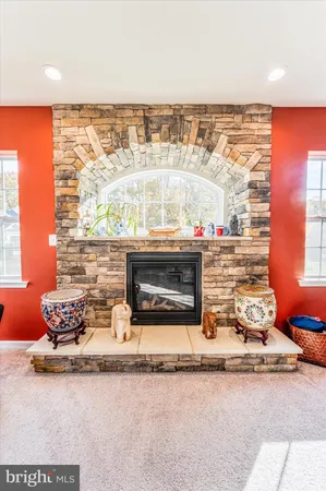a room with lots of books and a large window