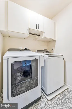 a view of a livingroom with workspace and a window