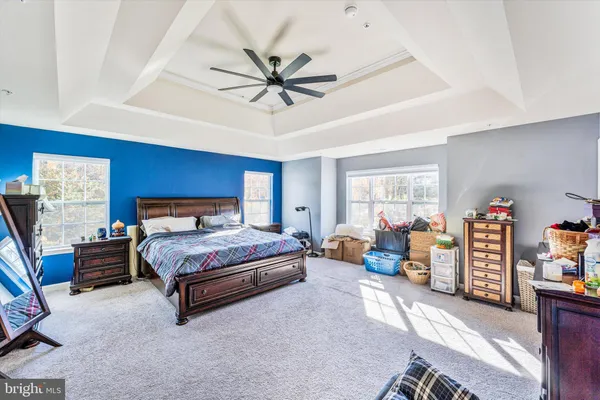 a living room with furniture and a book shelf