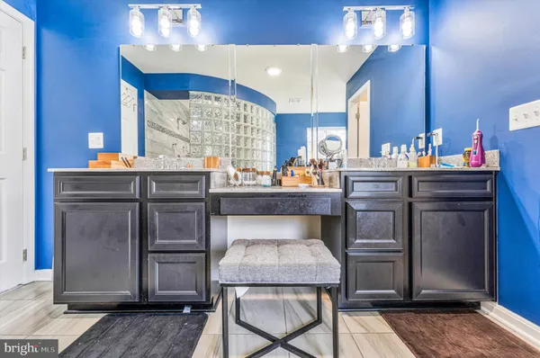 a picture of a room that has a painting on it and a table