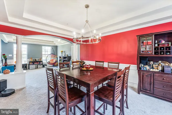 a kitchen with stainless steel appliances kitchen island granite countertop a dining table chairs and granite counter tops