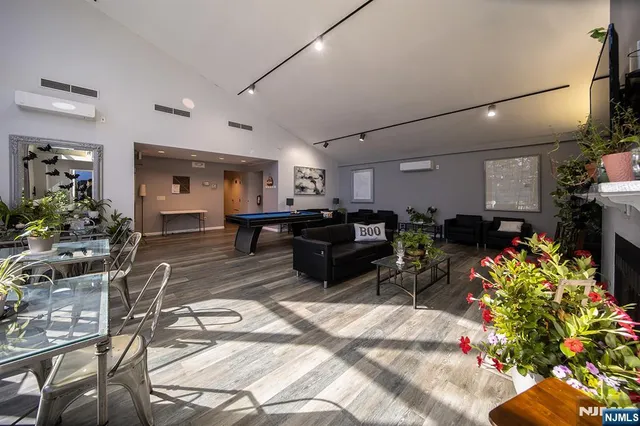 a living room with furniture and a chandelier