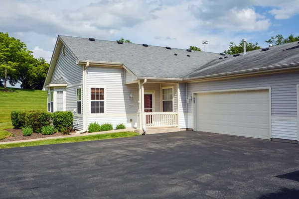 a front view of house with yard and green space