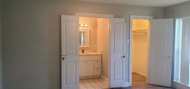 a view of bathroom with a door and wooden door
