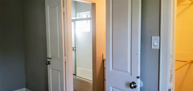 a bathroom with a glass shower door