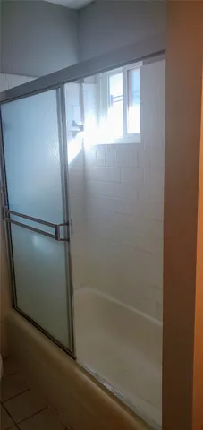 a bathroom with a glass shower door