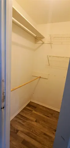 a view of a room with wooden floor