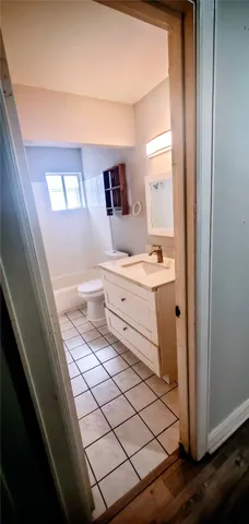 a bathroom with a sink mirror and vanity