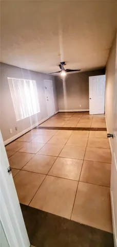 a view of an empty room with windows