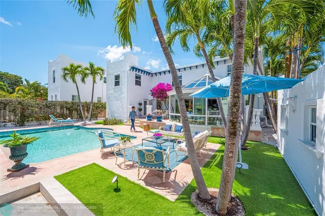 a view of a backyard with plants and patio