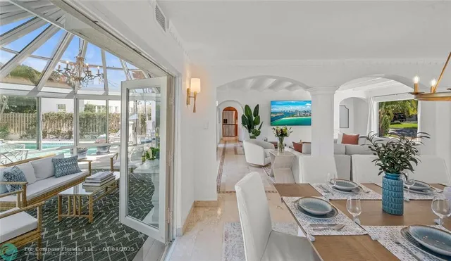 a room with lots of wooden furniture and glass door