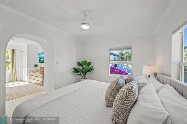 a bedroom with a bed and a painting on the wall