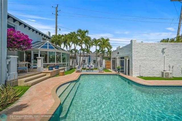 a front view of a house with outdoor seating