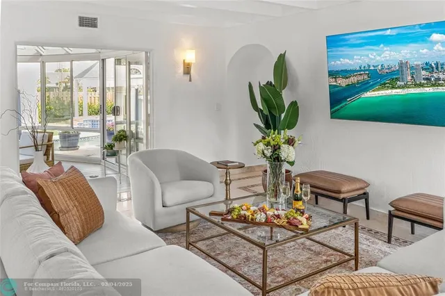 a living room with furniture a lamp and a potted plant