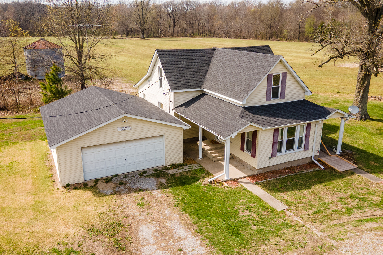 an aerial view of a house with a yard and lake view