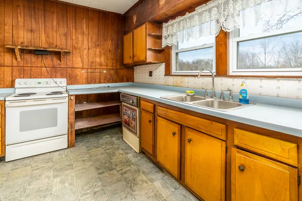 a kitchen with sink cabinets and window
