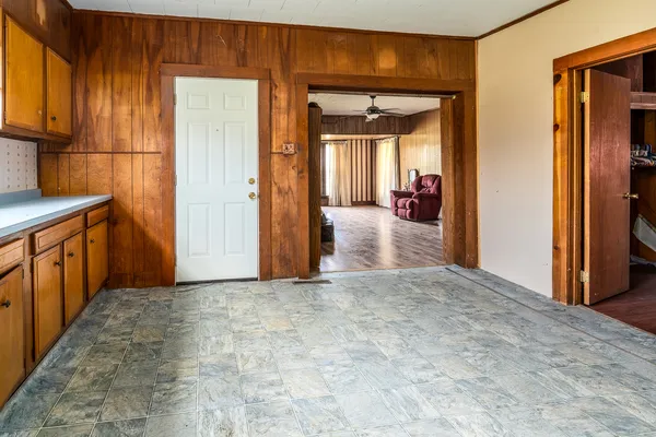 a view of a hallway with wooden shelves