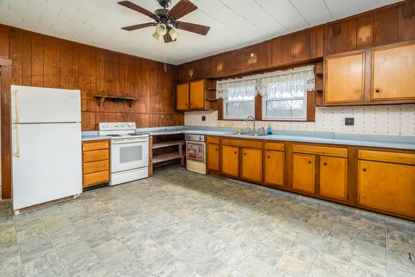 a kitchen with stainless steel appliances granite countertop a stove sink and cabinets