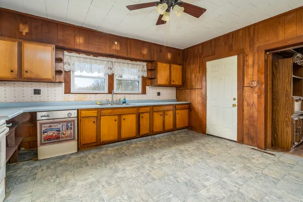 a large kitchen with stainless steel appliances granite countertop a sink and cabinets