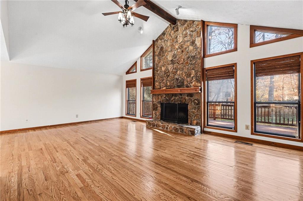 2711 Old Coach Road Duluth, GA 30096 - Photo 13 of 33 an empty room with wooden floor fireplace and windows