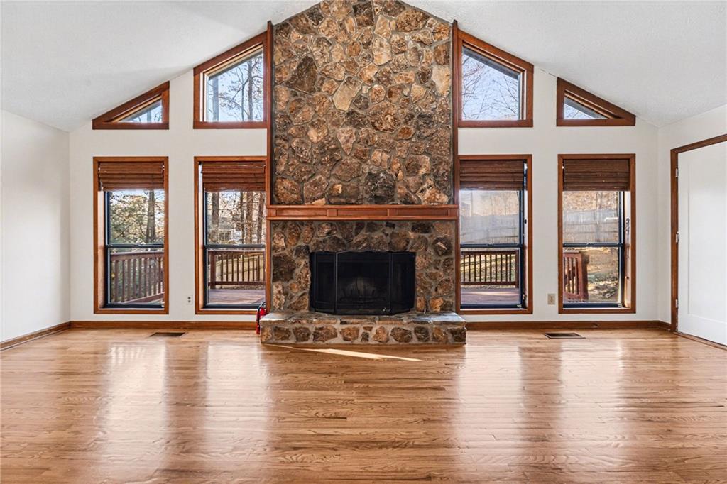 2711 Old Coach Road Duluth, GA 30096 - Photo 14 of 33 a living room with a fireplace and wooden floor