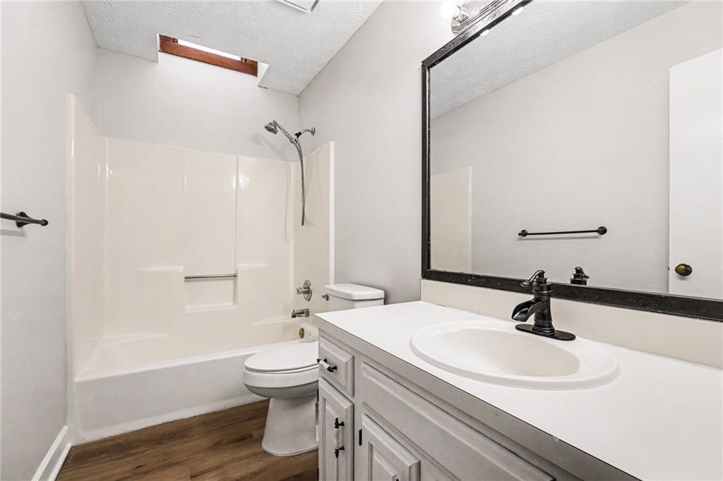 2711 Old Coach Road Duluth, GA 30096 - Photo 16 of 33 a bathroom with a sink a toilet and a mirror