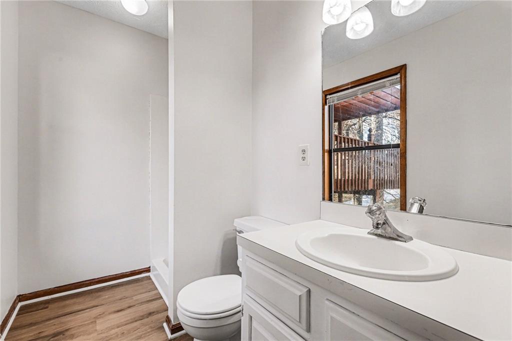 2711 Old Coach Road Duluth, GA 30096 - Photo 26 of 33 a bathroom with a sink a toilet and a mirror