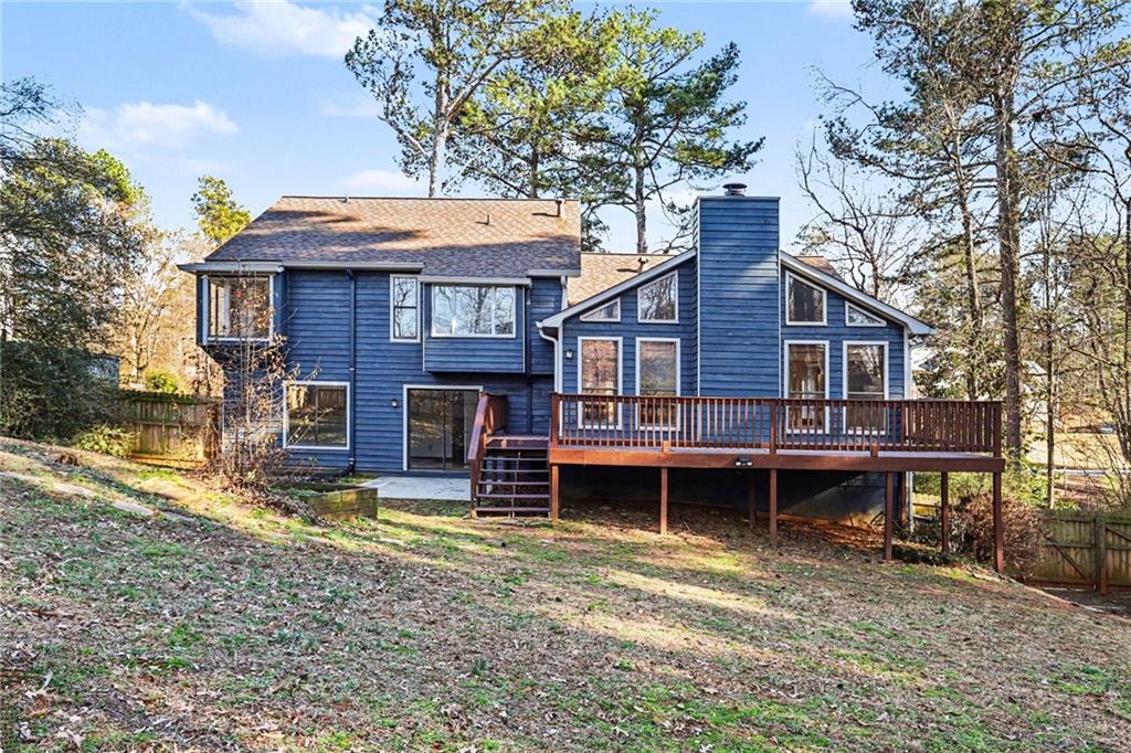 2711 Old Coach Road Duluth, GA 30096 - Photo 32 of 33 a backyard of a house with yard table and chairs