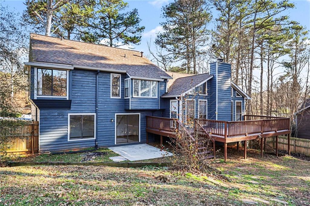 2711 Old Coach Road Duluth, GA 30096 - Photo 33 of 33 a view of a house with a yard chairs and wooden fence