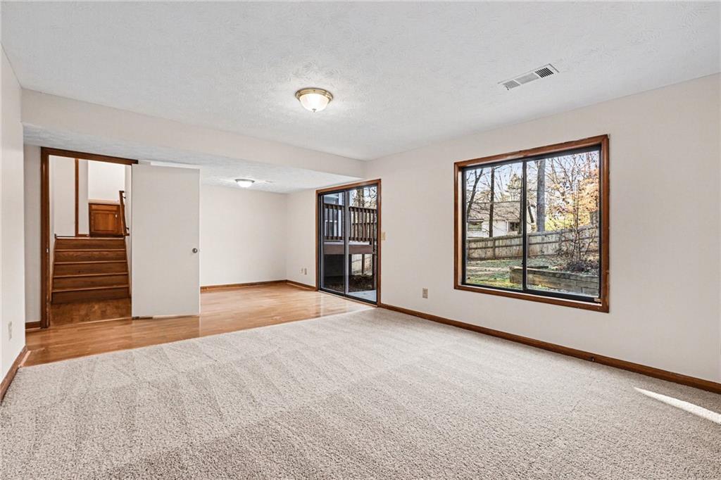 2711 Old Coach Road Duluth, GA 30096 - Photo 6 of 33 a view of an empty room with a fireplace and a window