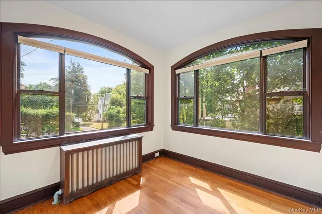a view of a room with window and wooden floor