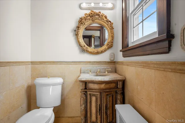a bathroom with a toilet a sink and a mirror