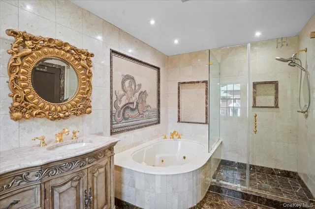 a bathroom with a tub sink and mirror
