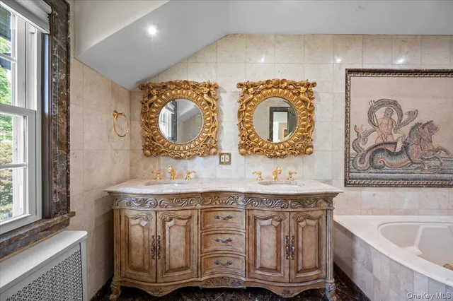 a bathroom with a double vanity sink and a bathtub