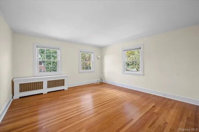 a view of a room with wooden floor and window