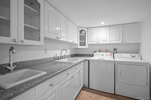 a view of a kitchen with sink and cabinets