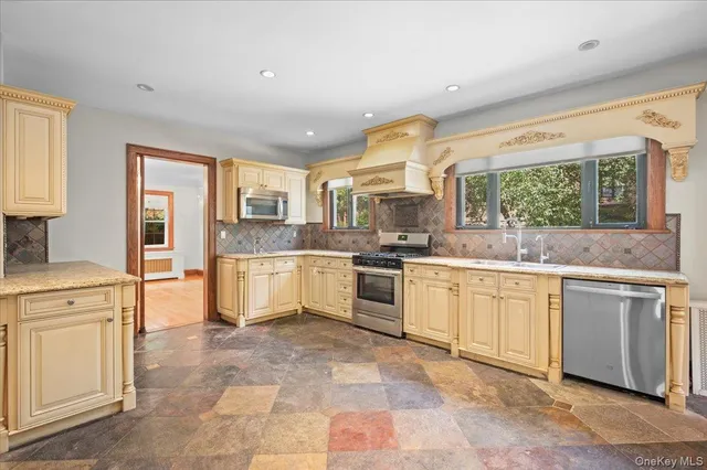 a kitchen with a stove a sink and a refrigerator