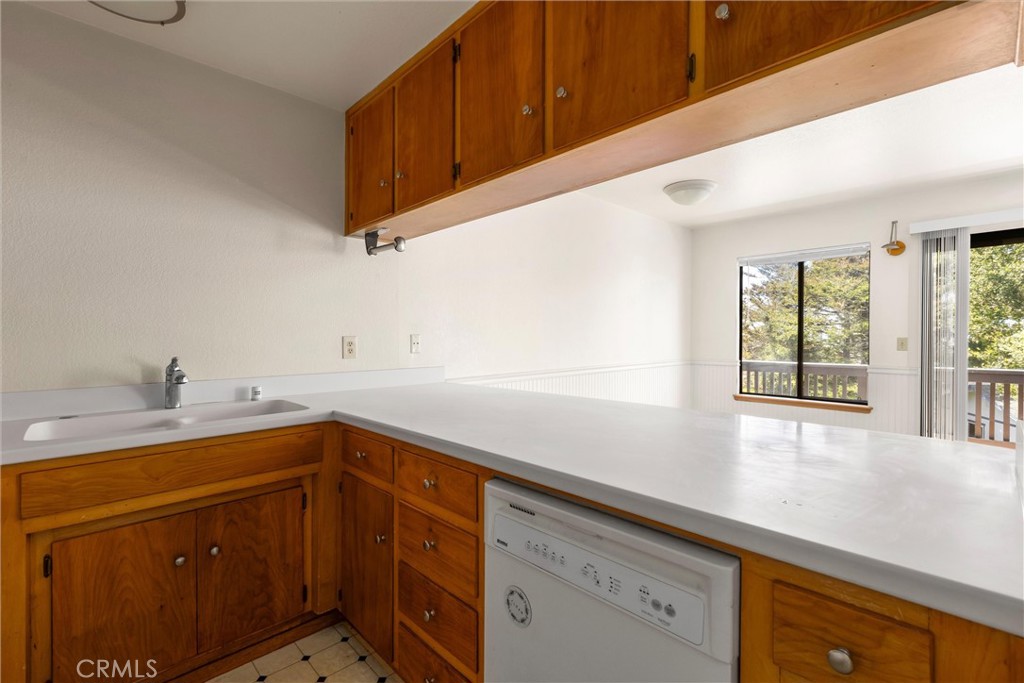 239 F Surf Street Morro Bay, CA 93442 - Photo 11 of 25 a kitchen with a sink cabinets and window