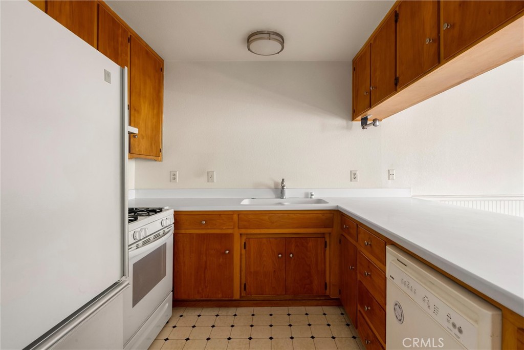 239 F Surf Street Morro Bay, CA 93442 - Photo 12 of 25 a utility room with cabinets a washer and dryer