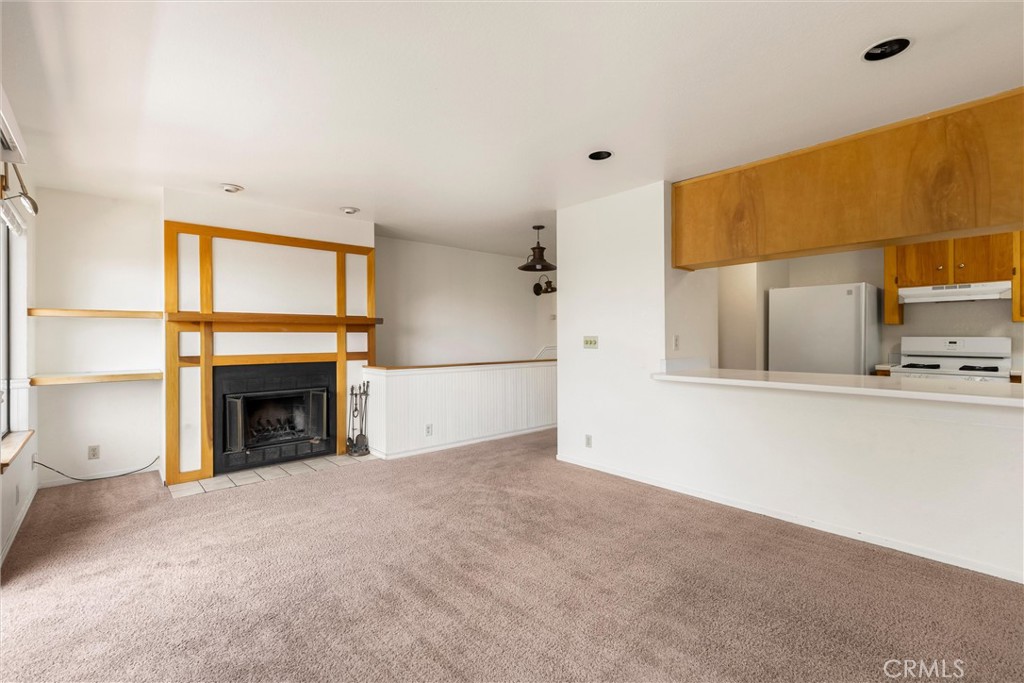 239 F Surf Street Morro Bay, CA 93442 - Photo 6 of 25 a view of a kitchen with a sink a fireplace and a window
