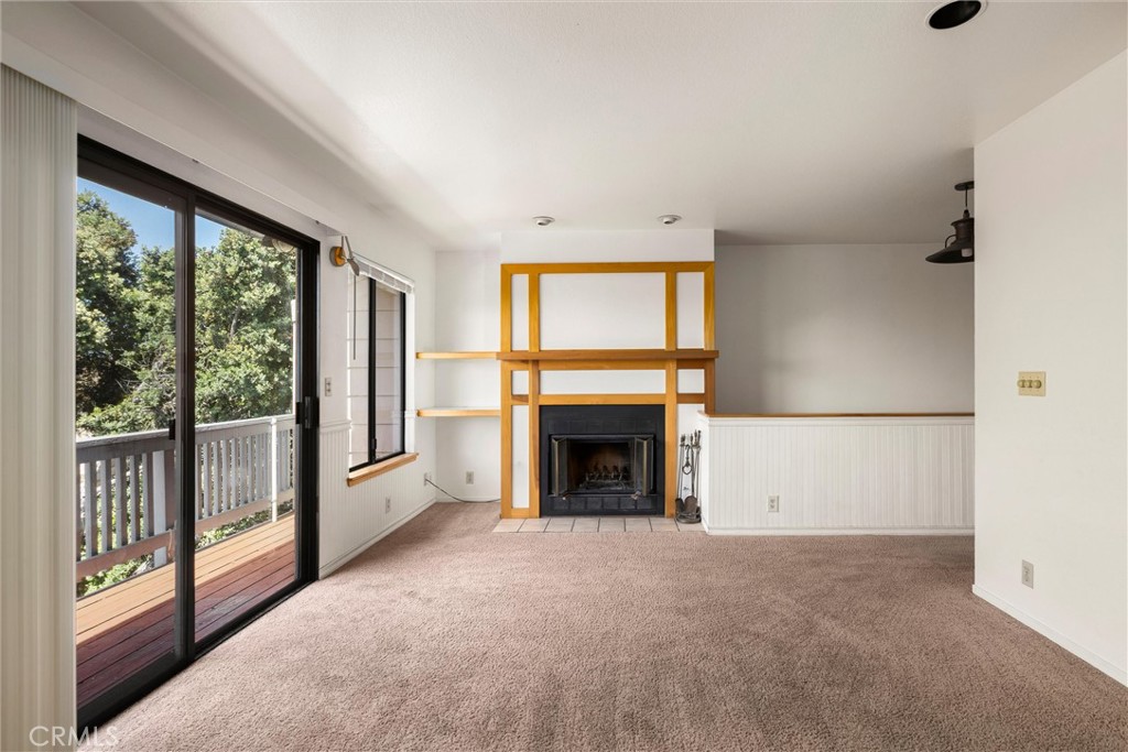 239 F Surf Street Morro Bay, CA 93442 - Photo 7 of 25 a view of an empty room with a fireplace and a window