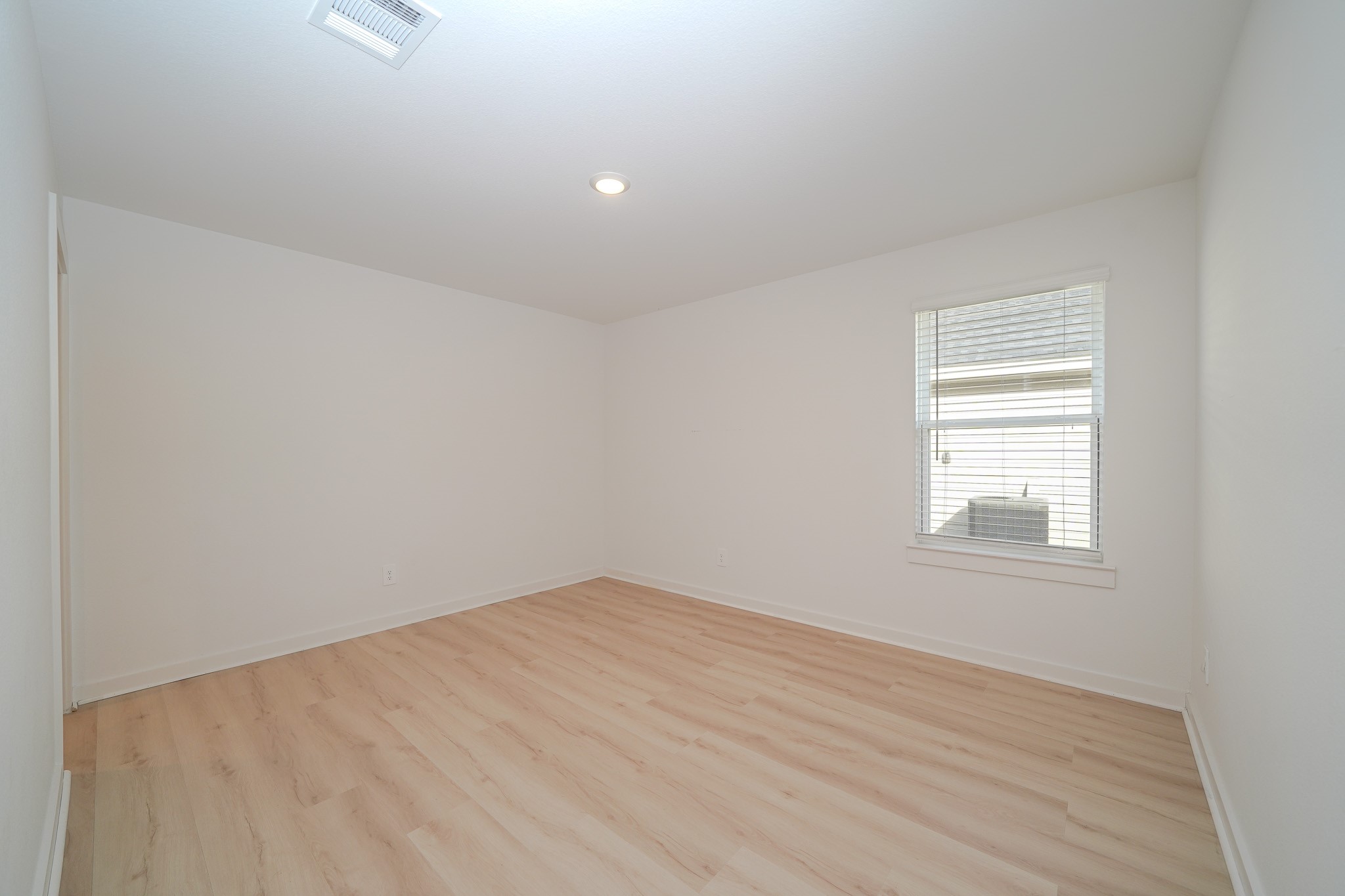 4526 Waving Willow Way Rosenberg, TX 77469 - Photo 12 of 40 an empty room with wooden floor and windows