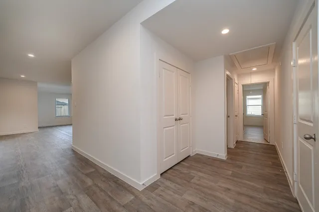 a view of hallway with wooden floor