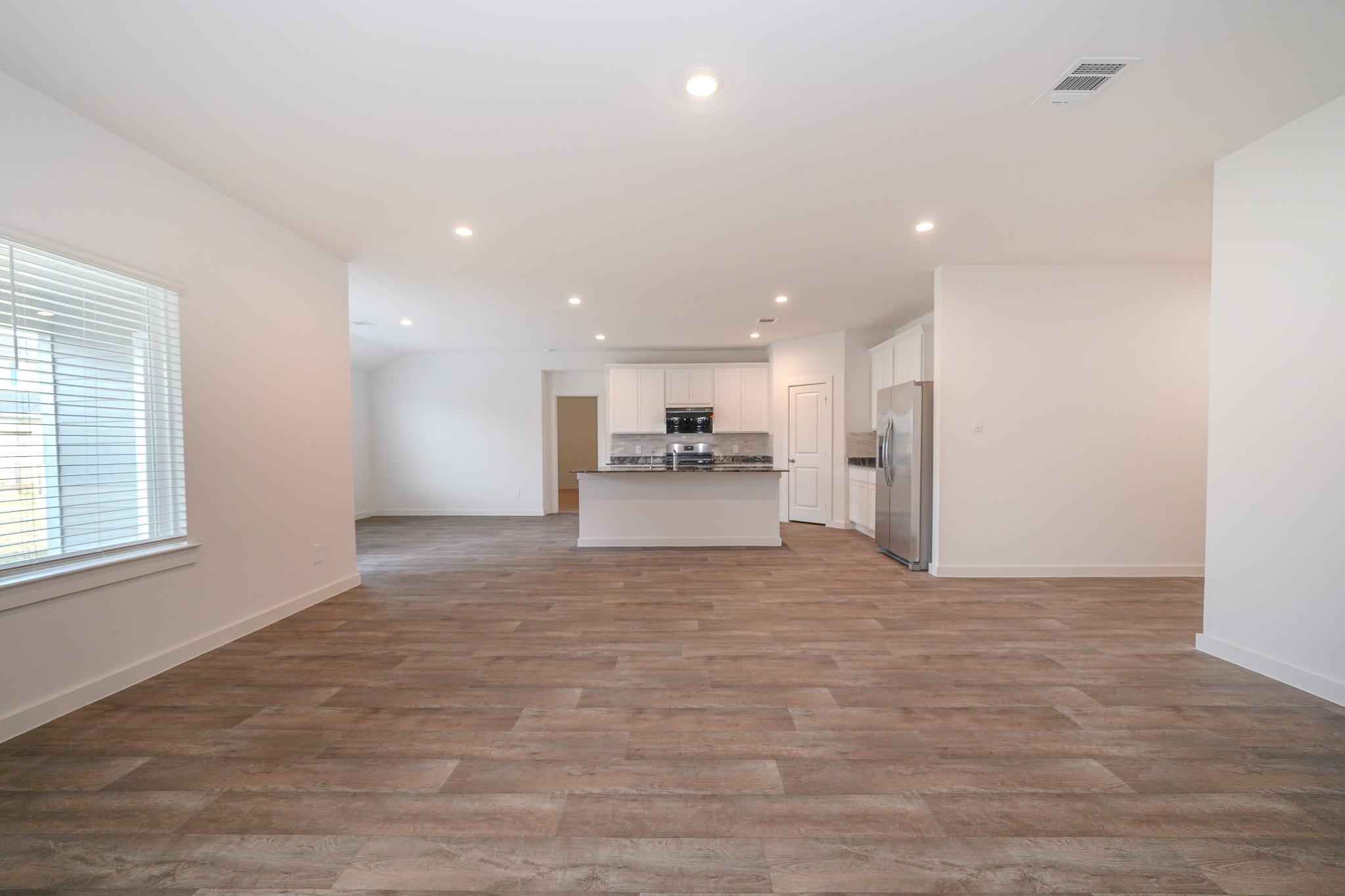 4526 Waving Willow Way Rosenberg, TX 77469 - Photo 16 of 40 a view of large kitchen with a refrigerator and a window